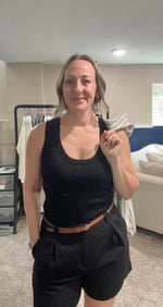 Load image into Gallery viewer, Women's black tank top with black pleated linen shorts and brown belt. 
